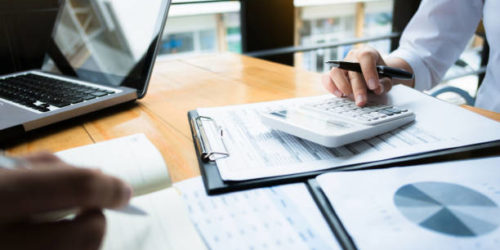business audits using a calculator financial data investment fund at a workplace, wealth concept